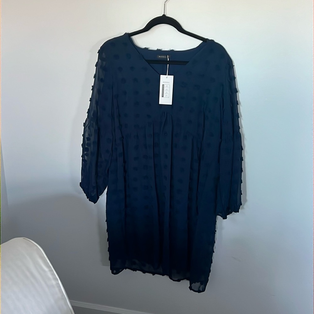 Navy blue dress with textured polka dots.
